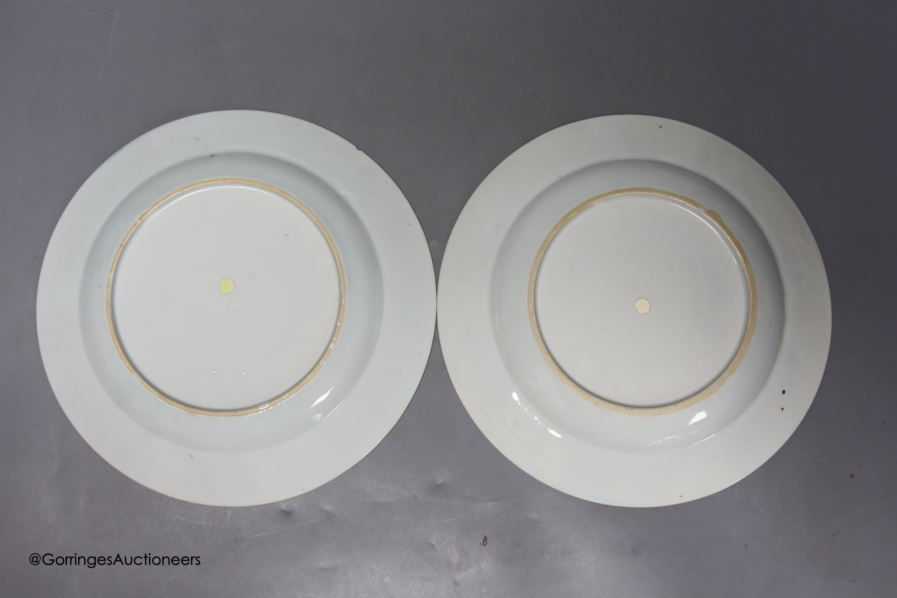A pair of 18th century Chinese famille rose plates and another similar, largest diameter 22.5cm (damage)